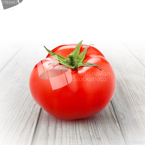 Image of red tomato isolated on wood