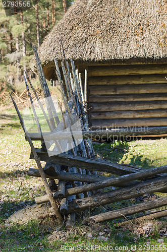 Image of Old rural building with a roof covered by straw, close-up