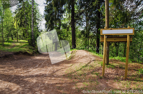 Image of Wooden sign board on the natural trail. In the 
 forest park