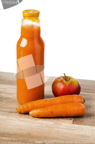 Image of Bottle with carrots juice and an apple