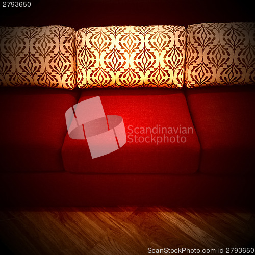 Image of Red sofa with decorative cushions