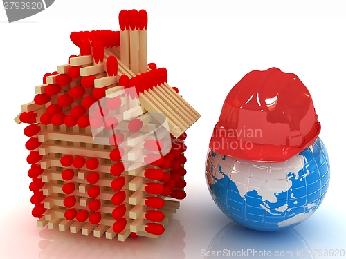 Image of Log house from matches pattern and hard hat on earth 