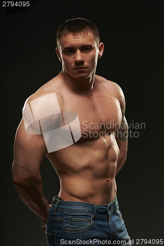 Image of Muscle man posing in studio