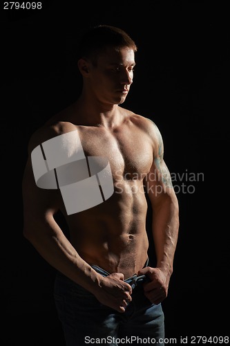 Image of Muscle man posing in studio