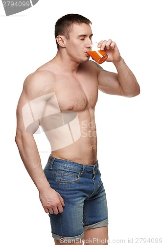 Image of Muscular male drinking juice