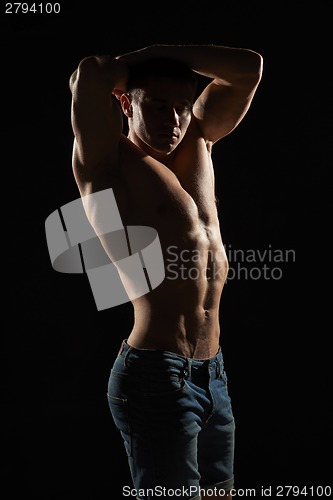 Image of Muscle man posing in studio