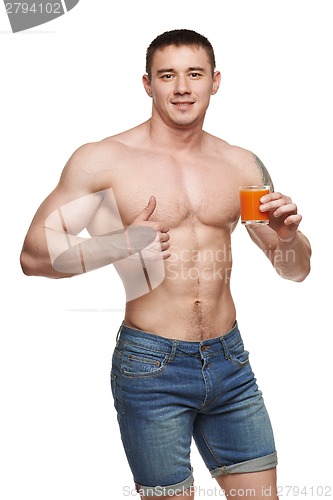 Image of Fit male holding vegetables and showing thumbs up