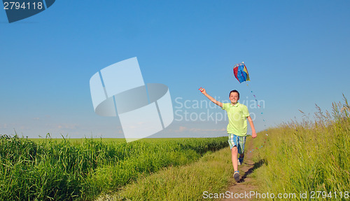 Image of boy  running with kite