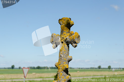 Image of old antique mossy metallic cemetery cross 