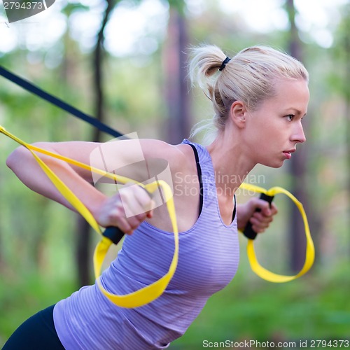 Image of Training with fitness straps outdoors.