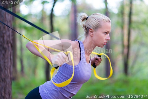 Image of Training with fitness straps outdoors.