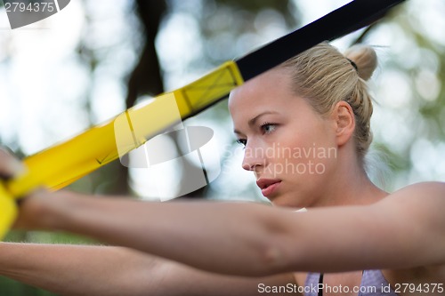 Image of Training with fitness straps outdoors.