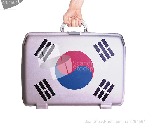 Image of Used plastic suitcase with stains and scratches