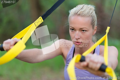 Image of Training with fitness straps outdoors.