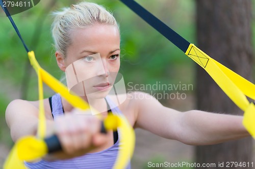 Image of Training with fitness straps outdoors.