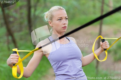 Image of Training with fitness straps outdoors.