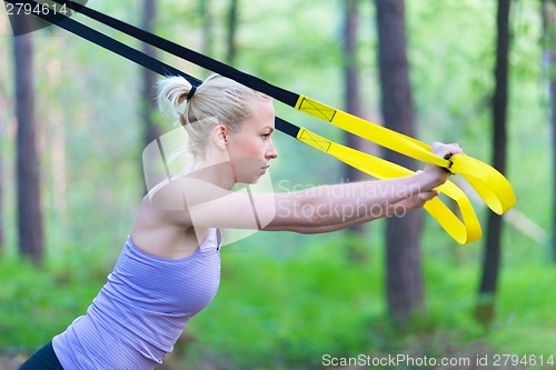 Image of Training with fitness straps outdoors.