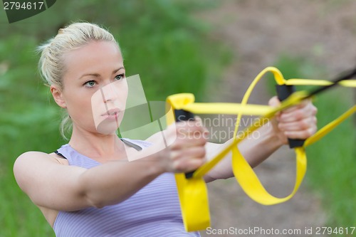 Image of Training with fitness straps outdoors.