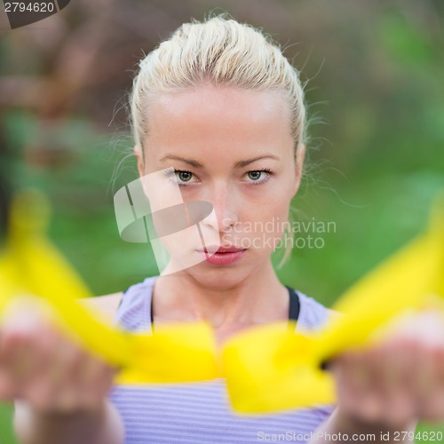 Image of Training with fitness straps outdoors.