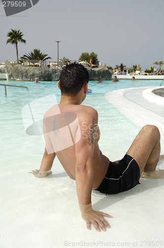 Image of Man relaxing in pool