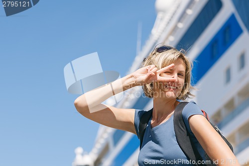 Image of Woman with map, in front of cruise liner