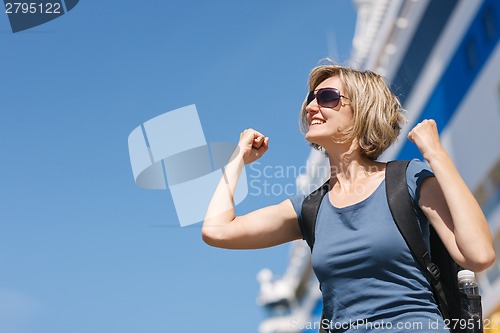 Image of Woman with map, in front of cruise liner