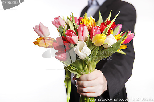 Image of A hand full of colorful tulips