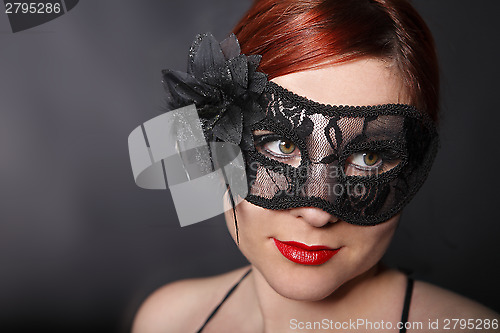 Image of Red head woman wearing mask
