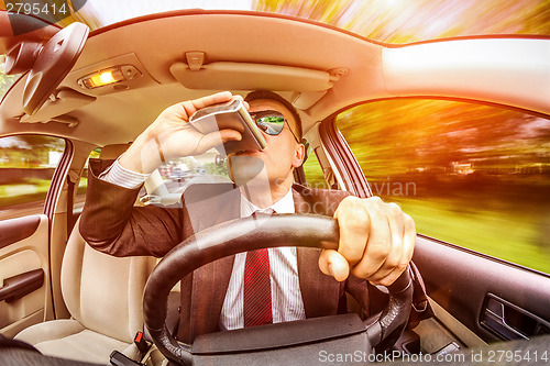 Image of Drunk man driving a car vehicle.