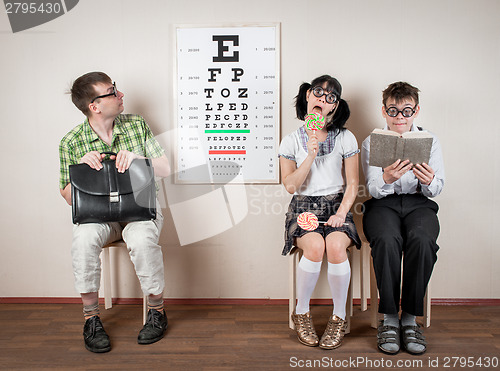 Image of Three person wearing spectacles in an office at the doctor