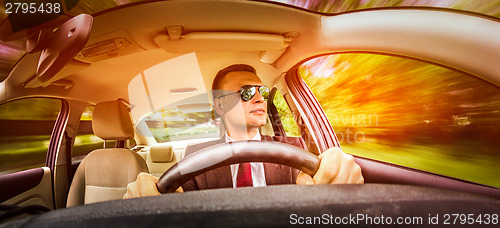 Image of Man driving a car.