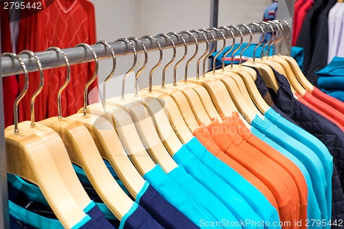 Image of Clothing on hangers in shop