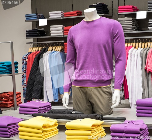 Image of Clothing on hangers in shop