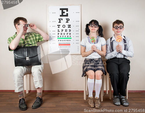 Image of Three person wearing spectacles in an office at the doctor