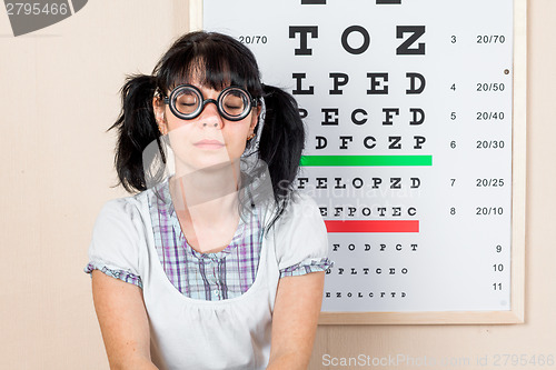 Image of Funny woman wearing spectacles in an office at the doctor