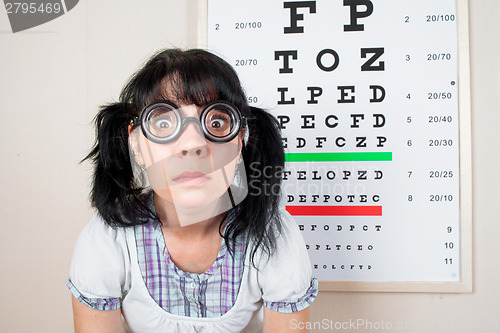 Image of Funny woman wearing spectacles in an office at the doctor