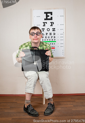 Image of Funny manwearing spectacles in an office at the doctor