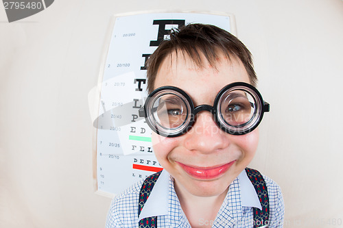 Image of Funny boy wearing spectacles in an office at the doctor