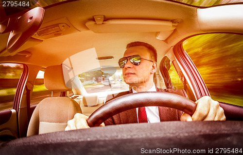 Image of Man driving a car.