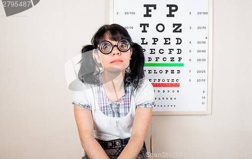 Image of Funny woman wearing spectacles in an office at the doctor