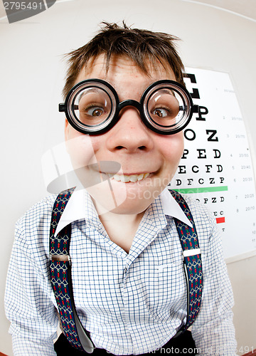 Image of Funny boy wearing spectacles in an office at the doctor