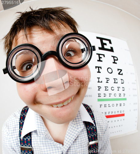 Image of Funny boy wearing spectacles in an office at the doctor