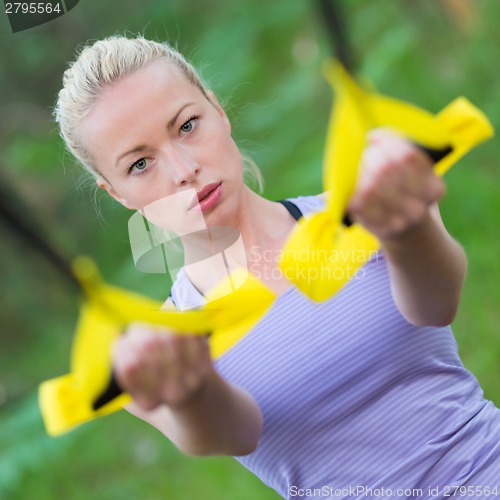 Image of Training with fitness straps outdoors.