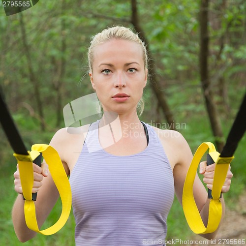 Image of Training with fitness straps outdoors.