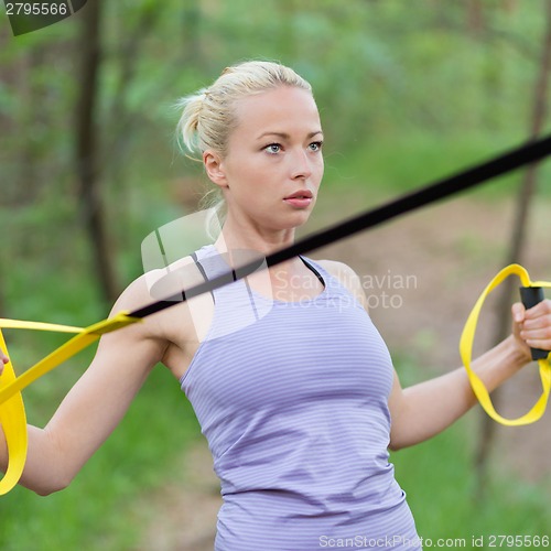 Image of Training with fitness straps outdoors.