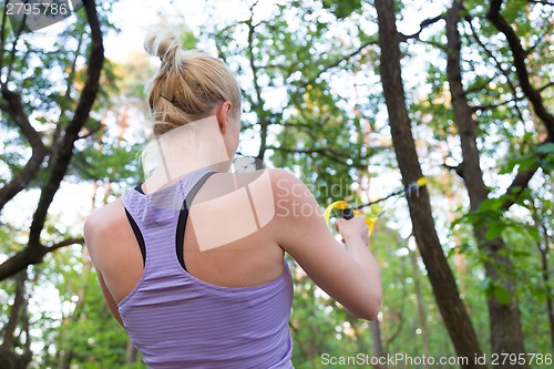 Image of Training with fitness straps outdoors.