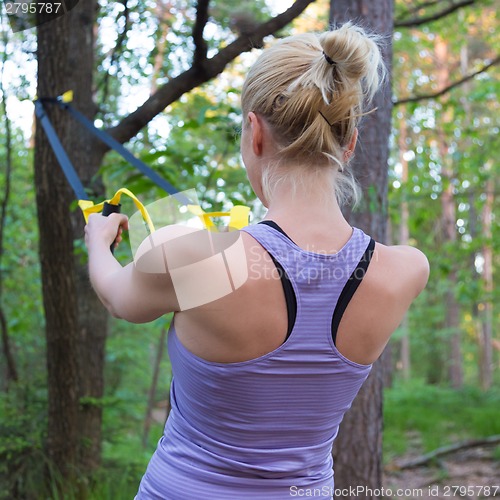 Image of Training with fitness straps outdoors.