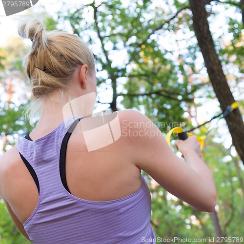 Image of Training with fitness straps outdoors.