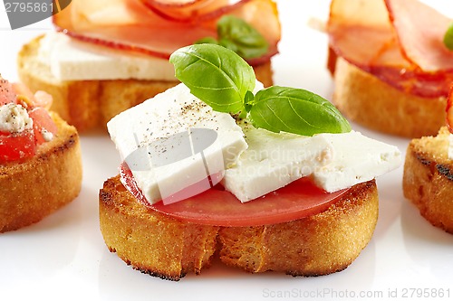 Image of Toasted bread with fresh goat cheese and tomato