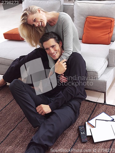 Image of happy couple watching tv